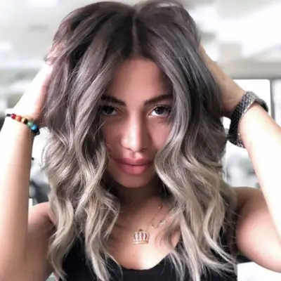 Woman with curled ash blonde hair