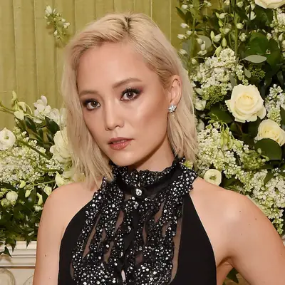 Pom Klementieff wears a warm ash blonde long bob