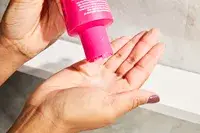 A person pouring the Viviscal Thickening Shampoo in their hand