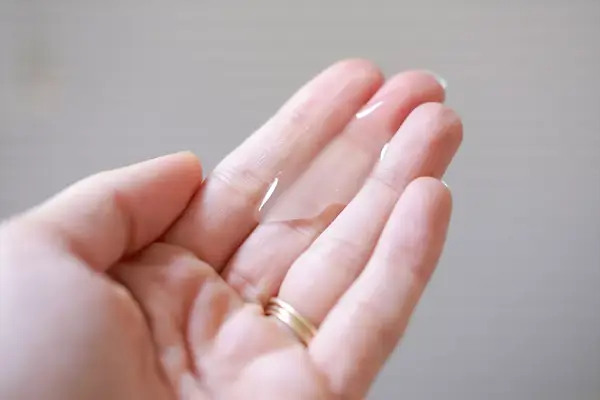 a person pouring Briogeo Destined For Density Caffeine + Biotin Density Shampoo into their hands