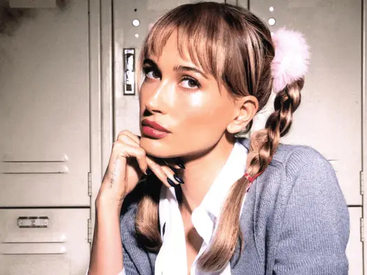 Hailey Bieber with Britney Spears Halloween costume featuring pigtail braids