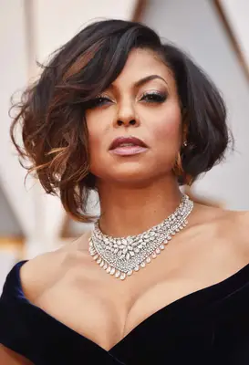 Taraji P. Henson with a bob and deep caramel, red-toned face-framing highlights