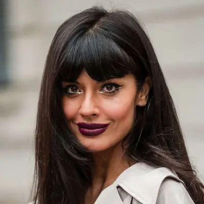 Jameela Jamil at Milan Fashion week wearings a subtle center part in her thick bangs