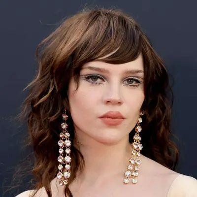 Sophie Thatcher attends an event in Hollywood with her long bangs pushed to the side in one subtle wave that matches her hair