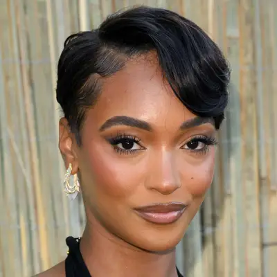 Jourdan Dunn wears a heavy side-parted bang that subtly blends into her pixie
