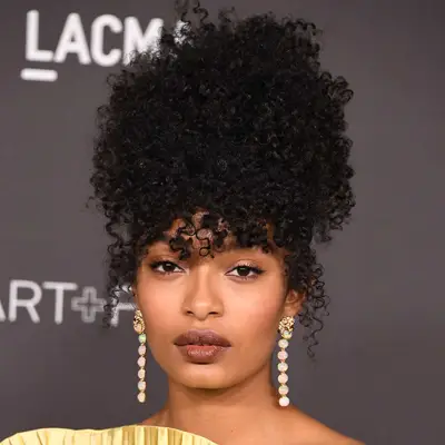 Yara Shahidi wears her fringe in natural curls to an event at LACMA