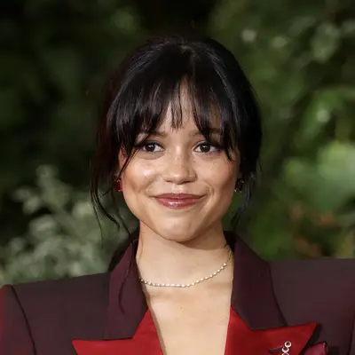 Jenna Ortega in a wispy long fringe that cascades into face framing pieces with her updo at the Beetlejuice Beetlejuice premiere