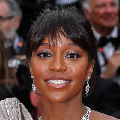 Aja Naomi King in Cannes with a feathered fringe and updo