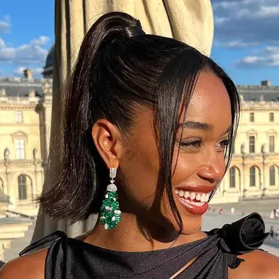 Laura Harrier wears a flippy ponytail