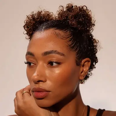 Woman wears curly space buns