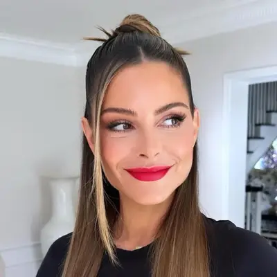 Maria Manounos wears her straightened hair in a half up bun