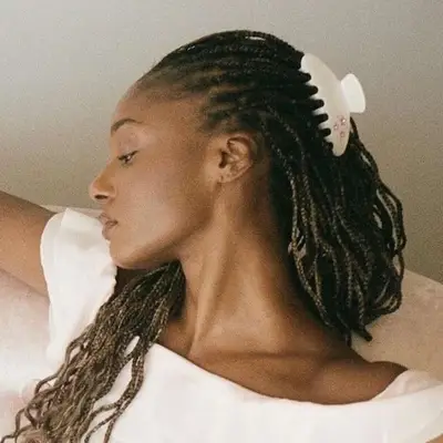 Model wearing huge claw clip in her box braids