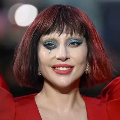 Lady Gaga with tousled bob in black cherry and vibrant cherry hues