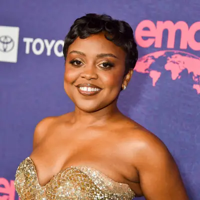 Quinta Brunson with a curly pixie 