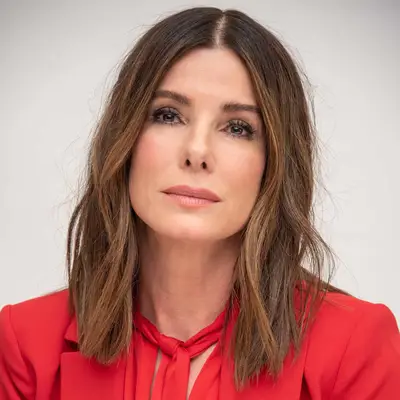 Sandra Bullock in red suit with wavy lob