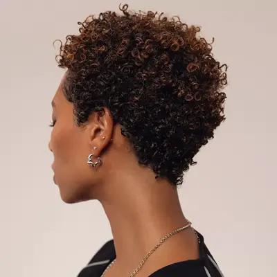 Short curly hair with bronze balayage tips