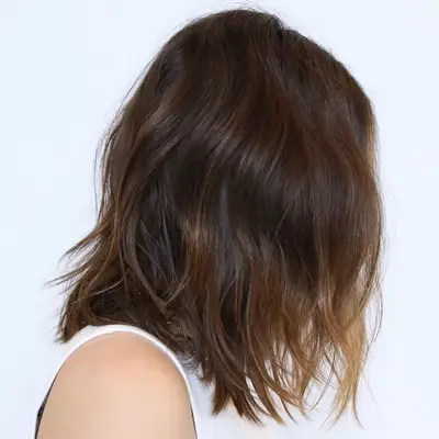 A brown wavy balayage lob