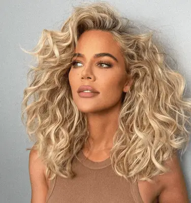 Khloe Kardashian wearing mid-length natural waves with tons of volume