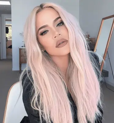 Khloe Kardashian wearing faded pastel pink hair color