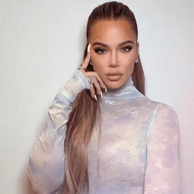 Khloe Kardashian with a sleek, chic half-up style