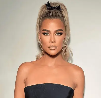 Khloe Kardashian wears a high sculpted ponytail with a bow on it