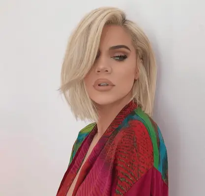 Khloe Kardashian with an over directed side part
