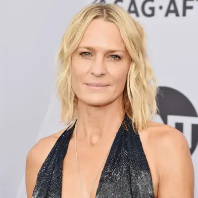 Robin Wright wears a long bob hairstyle with beach waves
