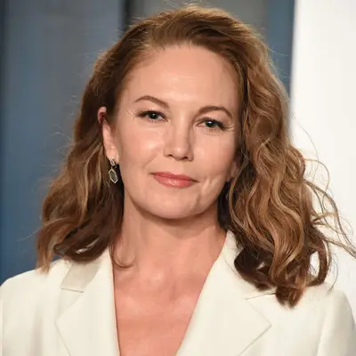 Diane Lane wears a voluminous shoulder-length wavy hairstyle