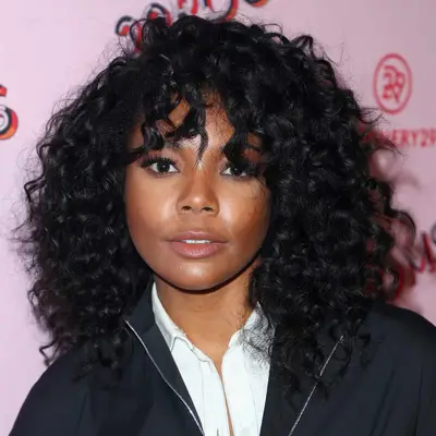 Gabrielle Union wears a shoulder-length curly hairstyle with face-framing bangs