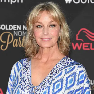 Bo Derek wears a long bob hairstyle with split face-framing bangs