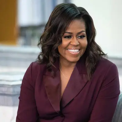 Michelle Obama wears a curled shoulder-length hairstyle