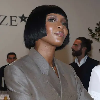 Naomi Campbell wears a short pageboy bob hairstyle with bangs