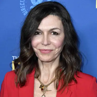 Finola Hughes wears a shoulder-length hairstyle with side part and waves