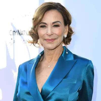 Giselle Fernandez wears a curled bob hairstyle with deep side part