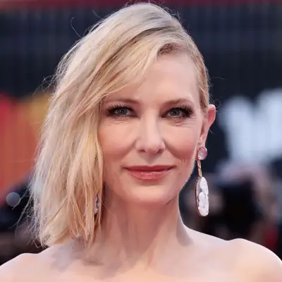 Cate Blanchett wears a long bob hairstyle with deep side part and one side pinned back
