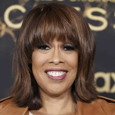 Gayle King wears a layered long bob hairstyle with full bangs