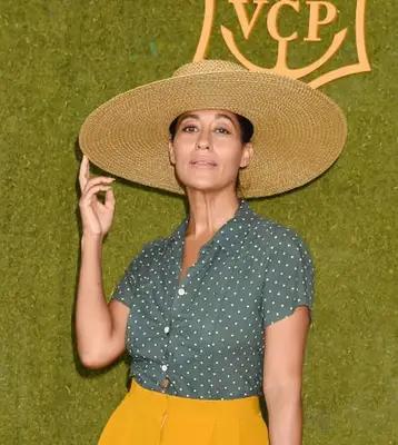 Tracee Ellis Ross with a large straw hat on the red carpet