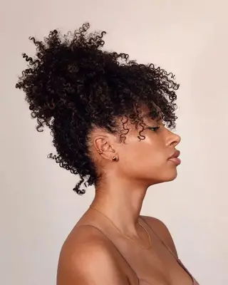 Person with a curly bun