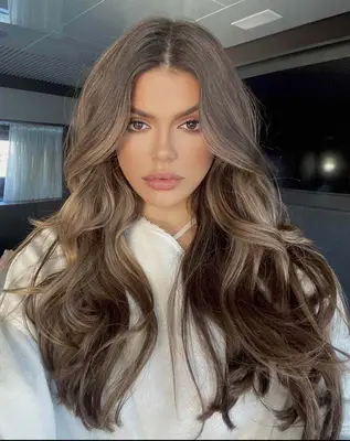 woman with cool-toned brown curls 
