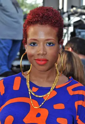 Kelis with curly red hair