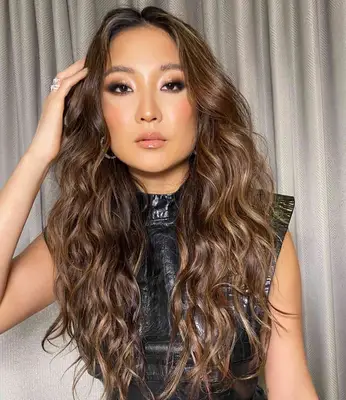 Actor Ashley Park with balayage hair