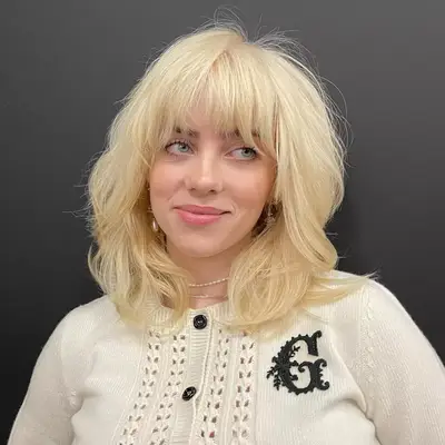 Billie Eilish with layered blonde bangs