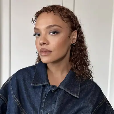 Tessa Thompson with curly microbangs and mullet