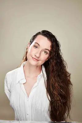 A woman with curly hair models the wet-hair look