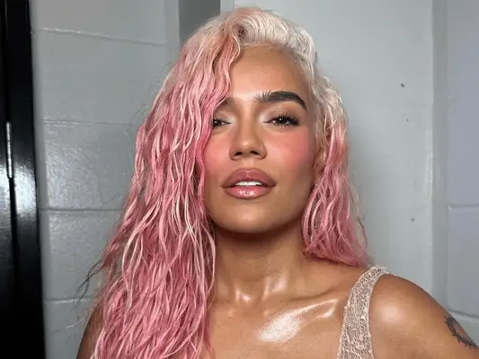 woman with pink hair styled in wet hair look