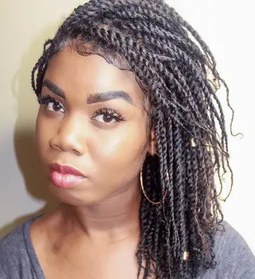 Woman with mini braids in a low updo