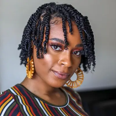 Woman wears mini twists and big hoop earrings