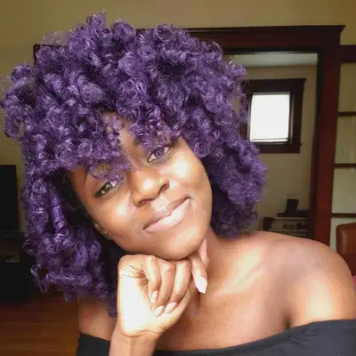 Woman with purple natural curls set with flexi-rods