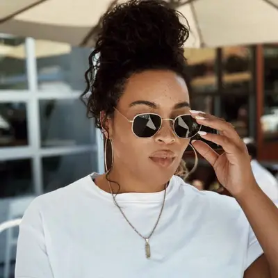 Sarah Shropshire wears messy bun and sunglasses