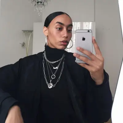 Nisa Maranda Jones takes mirror selfie wearing slicked-back bun and silver jewelry